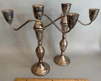 Pair of silver weighted candelabras