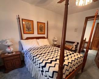 4 poster double bed with a King Koil mattress and boxspring. Bedside tables and bench.