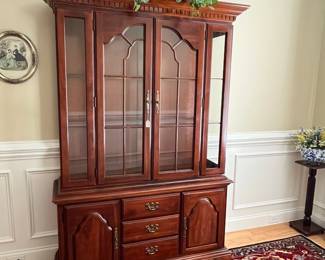 W72 - $150. American Drew Lighted China Cabinet - moves in 2 pieces. Measures 52" wide x 16" deep x 78" tall. Base is 27". Top is 51". Solid wood - very good condition with a few minor marks. 2 glass shelves - not adjustable. 