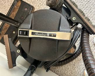 W65 - $150. Rainbow SE Vacuum. Does turn on but handle has tape "repair". Includes what is photographed. 