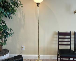 W55 - $20. Floor lamp with brass looking base and plastic shade. Measures 69" tall. 