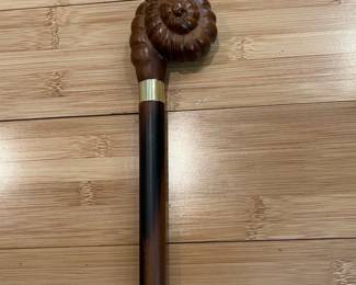 W31 - $40. Carved Shell Cane with brass band and solid wood cane. 