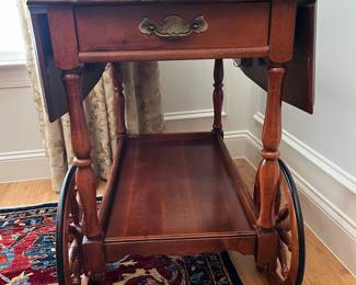 W9 - $125. Solid Wood Tea Cart with single drawer. Measures 33.5" x 19" (35.5" with leaves out) x 28" tall. 2 large wheels & 2 small wheels. Does roll easily. 
