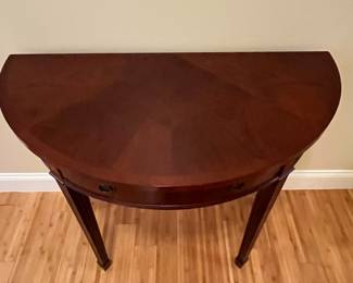 W10 - $65. Bombay Demilune Table. Has single drawer. Measures 35.5" wide x 17.75" deep x 30" tall. Some gentle wear marks on the legs. 