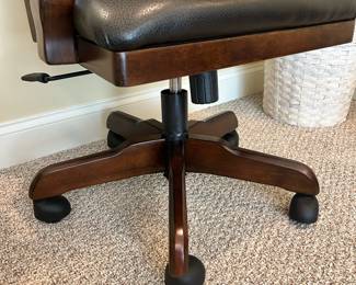 W57 - $40. Ashley Furniture Office Chair. 22" wide x 19.5" deep x 40" tall. Wood with faux leather seat. Very good condition.