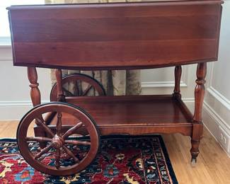 W9 - $125. Solid Wood Tea Cart with single drawer. Measures 33.5" x 19" (35.5" with leaves out) x 28" tall. 2 large wheels & 2 small wheels. Does roll easily. 