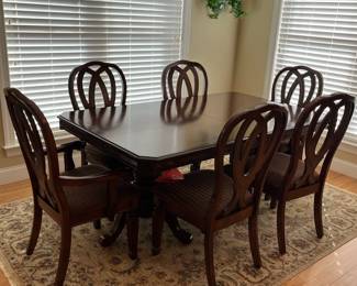 W12 - $300. Ashley Furniture Double Pedestal Table with 6 Chairs. Measures 42" wide x 70" x 30" tall. Has 1 leaf that can add another 18".  2 captains chairs - 4 regular. All sturdy and upholstery is in great condition!