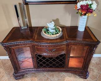 This is the matching buffet piece to the dining table set. It has interior lighting, wine rack front with large drawer for storage and best of all...THE TABLE LEAFS SLIDE INTO THE BACK!!!