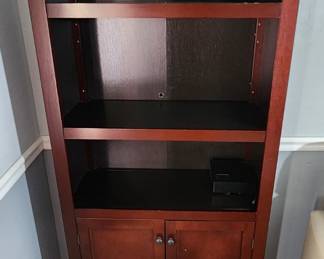 Wood bookshelf with storage cabinet.