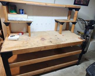 Custom built workbench. Sturdy yet built to handle abuse. Flat top is easy to take out and replace whenever it gets worn or stained with just a new piece of plywood to keep it look great forever!