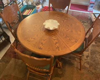 Oak Round wooden table, claw feet, four chairs.