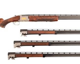 Engraved Deluxe Browning O/U Shotgun, 4 Barrel SetS/N 17550NM6A3. Engraved receiver with gold pheasant scene. Deluxe checkered stock. Four 28-inch barrel sets ranging from .410-12 Gauge. Modern