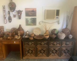 Collection of African masks, African pottery, assorted pottery, and 1960s Spanish Brutalist Sideboard