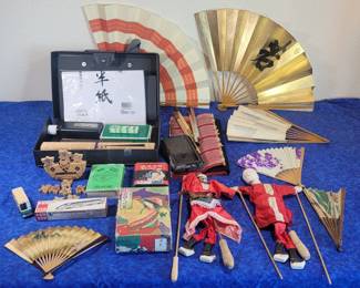 Japanese games and toys, calligraphy sets, sumo balancing game, rod puppets, New Year's poem cards, sumo playing cards, Shinkansen model train car, assorted fans.