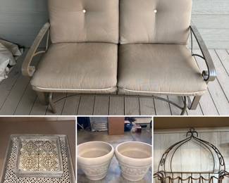 Kozyard Cozy Two Rocking Love Seats Glider Swing Bench/Rocker with tan cushions, set of nesting wooden trays with black and white patterned tile designs, two planters and a wrought iron wall basket planter with a rustic finish. 