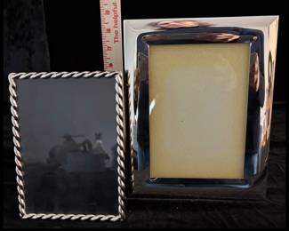 Pair of silver-plated picture frames. $25