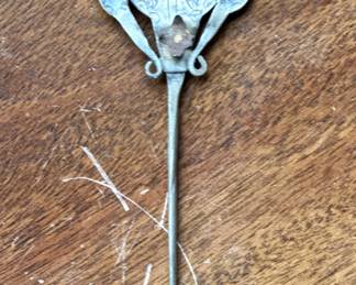 Antique Spanish Colonial South American silver cloak pin known as a ttipqui, tupo, or tupu, featuring a spoon shape with a floral design in the bowl