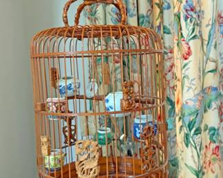 Vintage Chinese Bamboo Bird Cage featuring intricate carvings and porcelain feeding bowls 