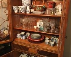 China cabinet. Lots of dishes, glassware, and oriental tea sets.