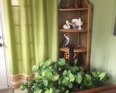 Corner wicker etagere, knickknacks, plants
