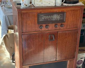 Montgomery Ward vintage radio and record player with record storage.