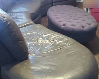 Curved Leather Sofa And Grey Tufted Ottoman