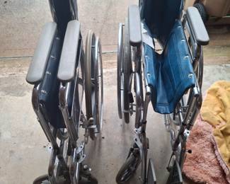 Pair of fold-up wheelchairs