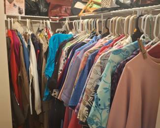 Lots of women's clothes and purses and shoes