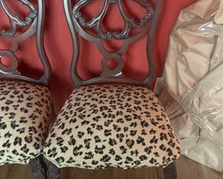 Antique carved wood side or dining chair in cherry finish with leopard print seat. 