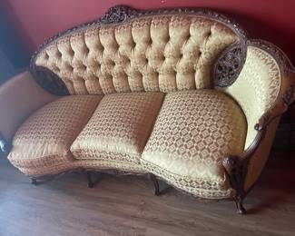 French Louis XV-style carved walnut sofa with gold-toned damask upholstery. 