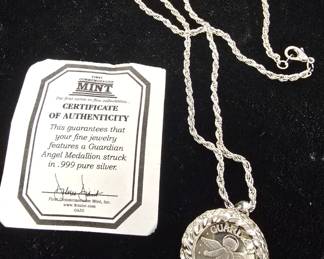 silver angel coin in bezel 