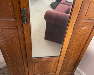 #8	Antique Armoire Carved wood with full length beveled mirror, hanging rack and pegs. 1 door. 33.5w x 15.5d x78h ( as is wear and door sticks)	 $ 125.00 																												