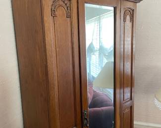 #8	Antique Armoire Carved wood with full length beveled mirror, hanging rack and pegs. 1 door. 33.5w x 15.5d x78h ( as is wear and door sticks)	 $ 125.00 																												