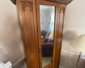 #8	Antique Armoire Carved wood with full length beveled mirror, hanging rack and pegs. 1 door. 33.5w x 15.5d x78h ( as is wear and door sticks)	 $ 125.00 																												