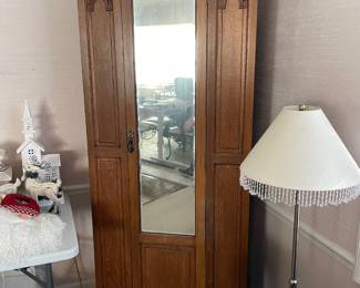 #8	Antique Armoire Carved wood with full length beveled mirror, hanging rack and pegs. 1 door. 33.5w x 15.5d x78h ( as is wear and door sticks)	 $ 125.00 																												