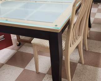 glass-covered table with 2 chairs