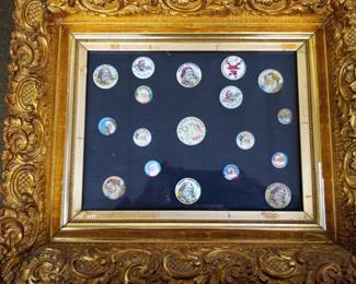 Santa antique pinbacks in frame.