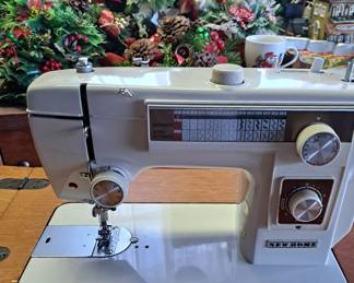 New Home sewing machine in cabinet
