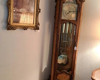 Framed art and grandfather clock
