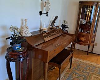 Nice piano with sheets and books of music, carved stands, bow front curio cabinet