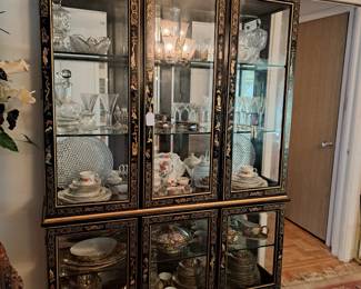 Oriental style display cabinet with glass shelves and mirrored back