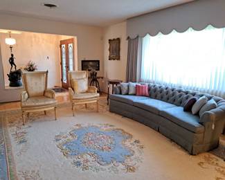 Button and tufted sofa, pastels area rug, two upholstered chairs