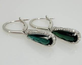 Each dazzling drop earring features a pear cut blue green tourmaline (approx 15mm x 5mm) surrounded by (29) round cut diamonds set in platinum. Weight of both earrings together is 6.4 gtw. 3.63 ctw of both tourmalines and 0.52 ctw of all diamonds. Includes appraisal dated July 1, 2025 by GemAssure Gemological Appraisals. Appraisal provided by consigner. 