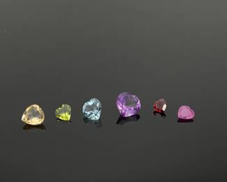 Six (6) heart cut gemstones: amethyst, citrine, topaz, ruby, peridot and garnet. 6.75 ctw. 