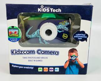 Vivitar KidsTech Kidzcam Camera, takes photos & videos with built in games, 2" color screen, 64 MB memory, and more. Camera appears new in box. See photos for details. 