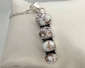 1.5" pendant of (4) wildhorse jasper cabochons descending in size. Set in unmarked silver tone, hanging from a 15" sterling silver chain, stamped "925". 13.07 gtw. 