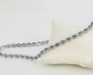 Platinum 17" necklace, stamped "Oscar Friedman" mounted with (49) oval cut sapphires weighing approximately 24.21 ctw. (588) round cut diamonds, weighing approximately 8.04 ctw surround each of the sapphires. Finished with a tension lock clasp and folding safety clasp. 36.6 gtw. Appraisal provided by consigner. 