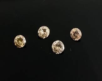 Four (4) 2.7 mm yellow to light brown round cut gemstones, appear to be champagne diamonds, but unable to verify. .35 ctw. 
