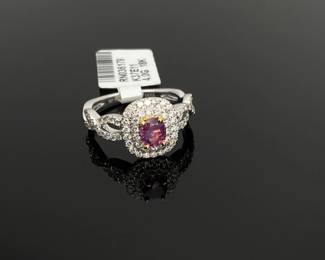 18K white and yellow gold size 6.5 ring, stamped HANA. Mounted with (1) genuine GIA certified pink Kashmir sapphire center stone weighing approximately 0.55 ct. (72) round diamonds, weighing approximately 0.58 ctw, surround the center stone. 4 gtw. Includes appraisal dated May 22, 2024 by American International Gemological Laboratories, Inc. Appraisal provided by consigner. 