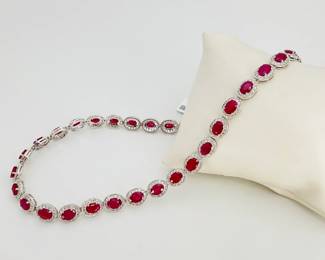(38) oval cut GIA Certified Burmese rubies are the focus of this platinum "Oscar Friedman" 16.75" necklace. Total carat weight of rubies is approximately, 30.41 ctw. (532) round brilliant cut diamonds surround each ruby, 5.44 ctw. Necklace is finished with a tension lock clasp and double safety clasps. 58.4 gtw. Includes appraisal dated February 25, 2025 by American International Gemological Laboratories, Inc. Appraisal provided by consigner. 